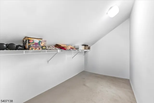 a view of storage and utility room with a fan