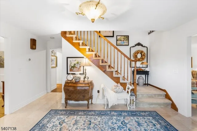 a living room with table and stairs