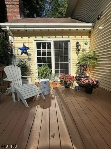 a view of a patio with couple of chairs and potted plants