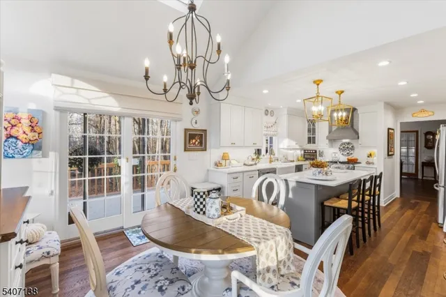 a living room with kitchen island furniture and a chandelier