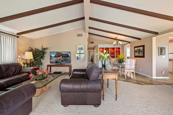 a living room with furniture and a ceiling fan