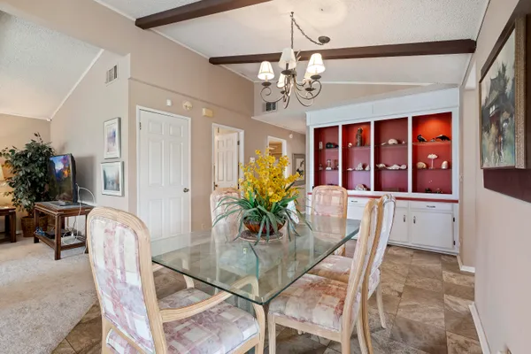 a dining room with furniture a livingroom and chandelier