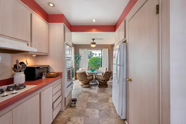a kitchen with a refrigerator and a sink