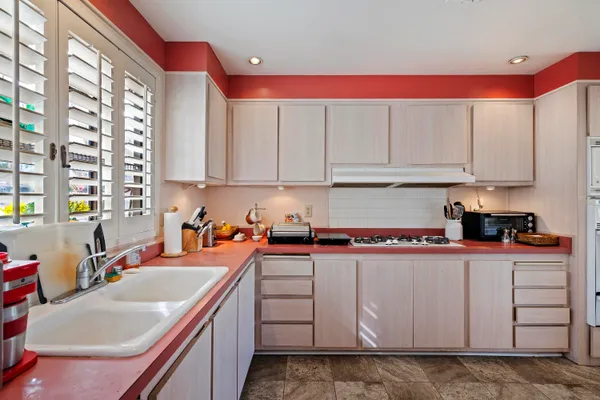 a kitchen with stainless steel appliances granite countertop a sink and cabinets