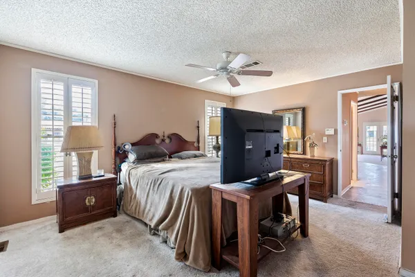 a bedroom with a bed and a chandelier