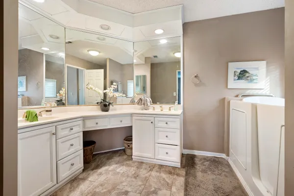 a spacious bathroom with a granite countertop sink mirror and a