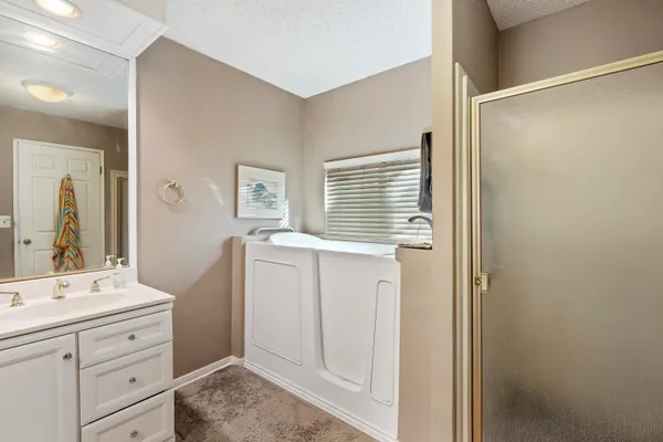 a bathroom with a window sink and a mirror