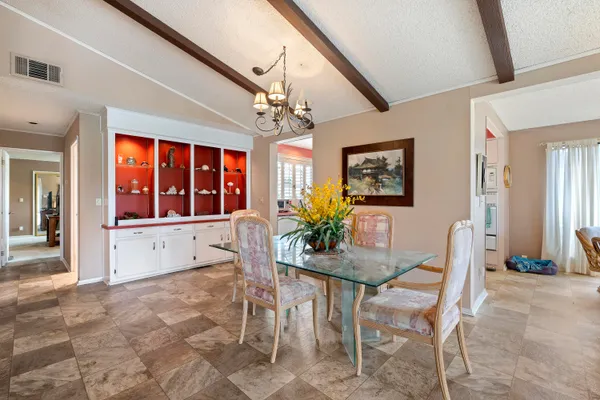 a dining room with furniture and window
