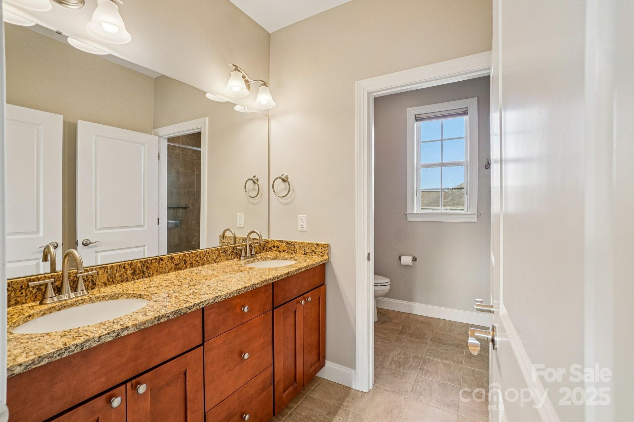 14 Rose Creek Road Leicester, NC 28748 - Photo 11 of 34 a bathroom with a granite countertop double vanity sink a mirror and a