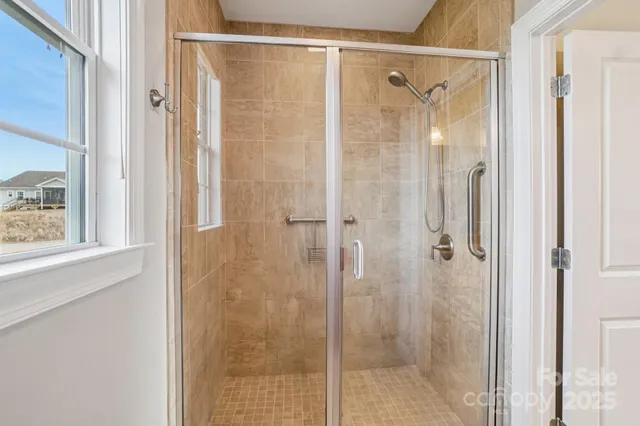 a bathroom with a glass shower door