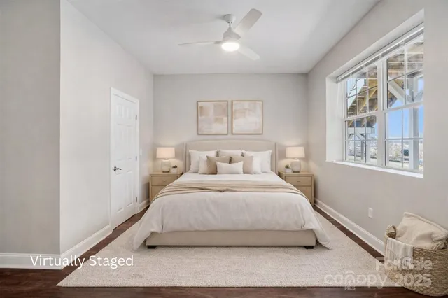 a large white bed sitting in a room next to a window