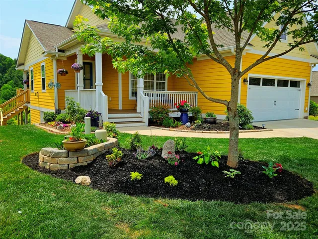 a view of a house with a backyard and garden