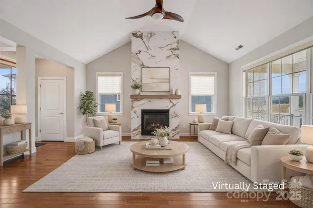 a living room with furniture and a fireplace