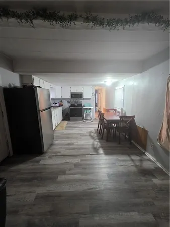 a living room with furniture and a dining table with kitchen view