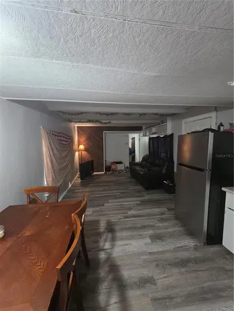 a room with a bed and a television