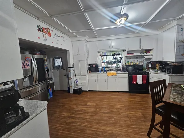 a kitchen with stainless steel appliances granite countertop a refrigerator and a stove top oven