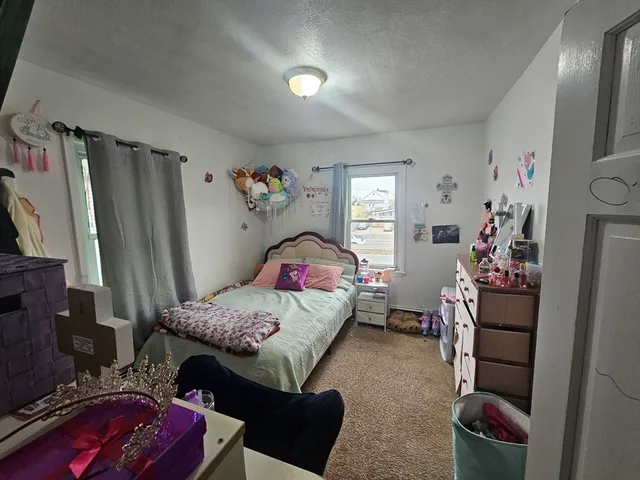 a bedroom with furniture and a window