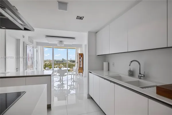 a kitchen with a sink and a large window