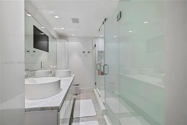a bathroom with a tub a sink and mirror