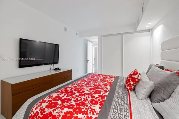 a living room with a flat screen tv and a rug