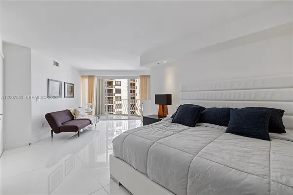 a bedroom with a bed and couch