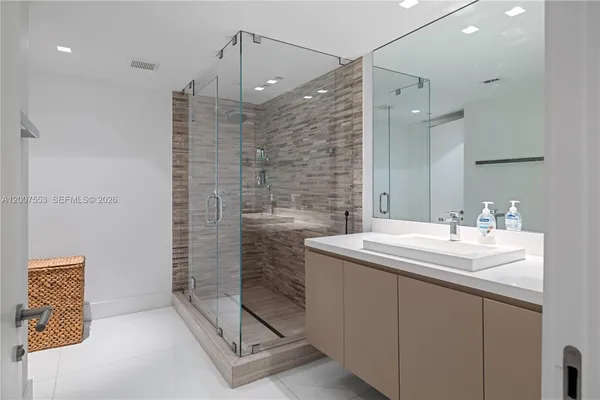 a bathroom with a sink a vanity and shower