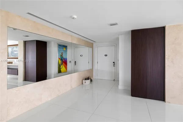 a large room with lots of painting on the wall