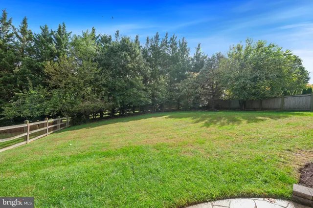 a view of a yard with a house in the background