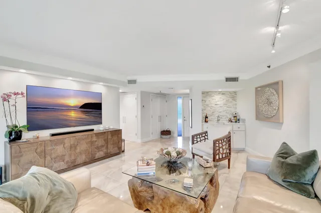 a living room with furniture and kitchen view