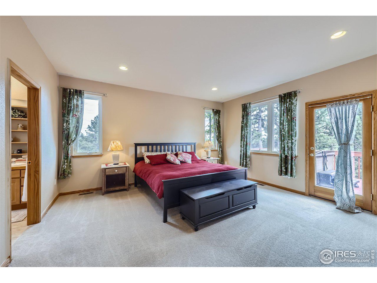 641 Ranch Road Ward, CO 80481 - Photo 13 of 40 a spacious bedroom with a bed and large window