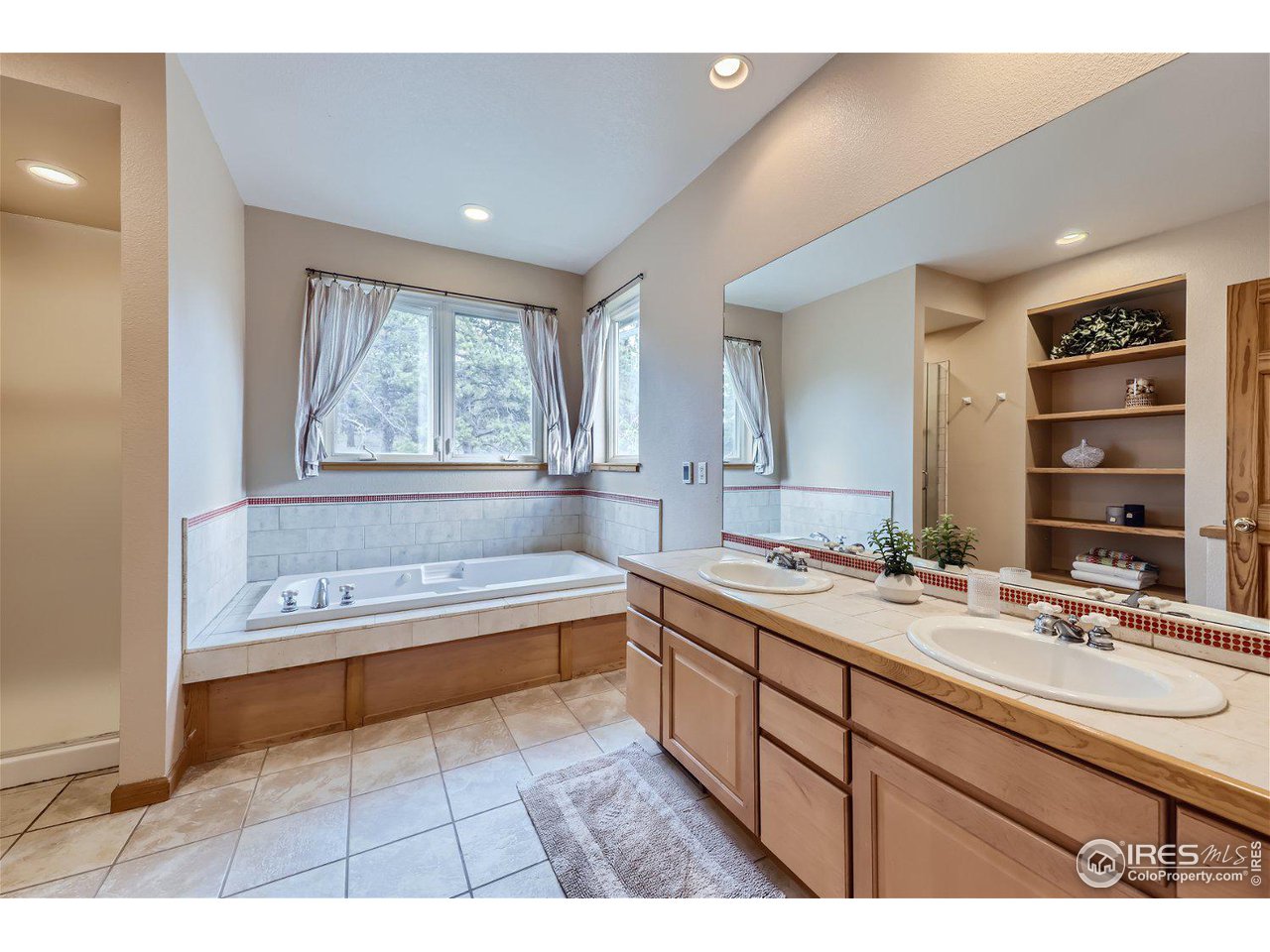 641 Ranch Road Ward, CO 80481 - Photo 16 of 40 a spacious bathroom with a tub sink and mirror