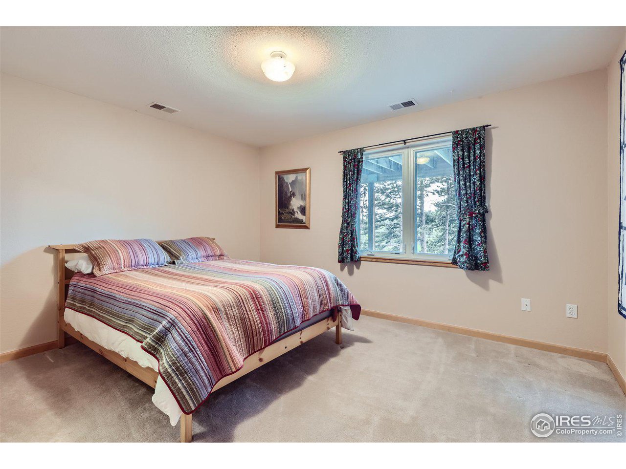 641 Ranch Road Ward, CO 80481 - Photo 18 of 40 a bedroom with a bed and a window