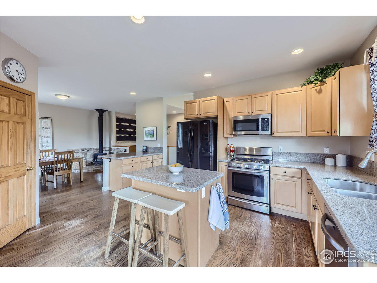 641 Ranch Road Ward, CO 80481 - Photo 10 of 40 a kitchen with stainless steel appliances kitchen island granite countertop a stove top oven a sink dishwasher and cabinets with wooden floor