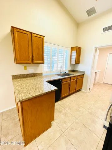 a kitchen with stainless steel appliances granite countertop a sink and a refrigerator