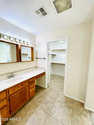 a spacious bathroom with a sink a mirror and a bathtub