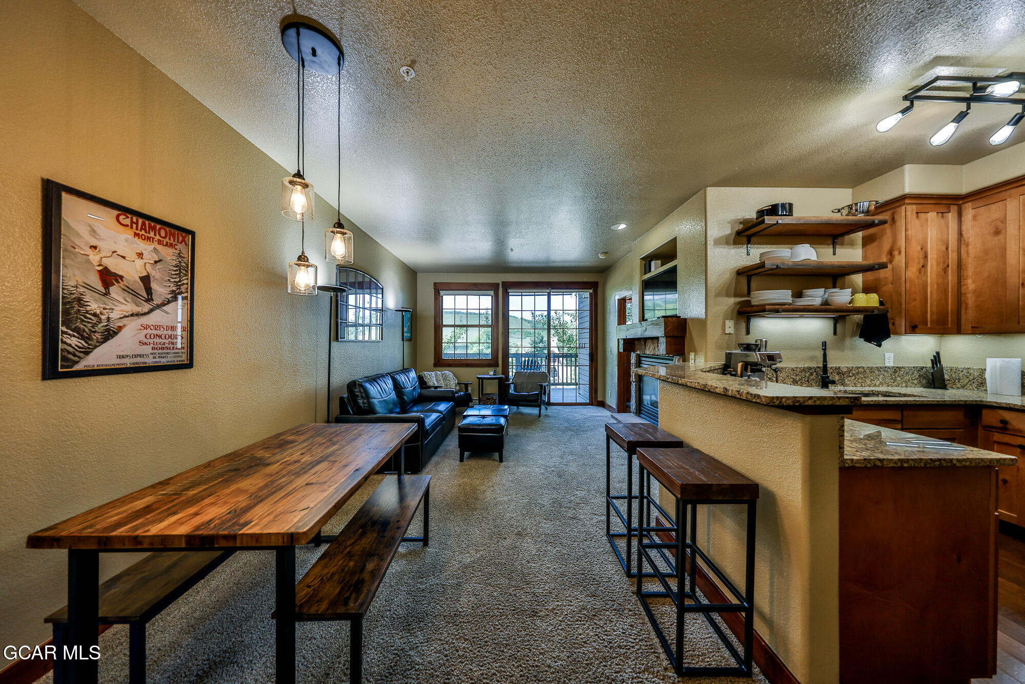 5202 Northstar, Unit 5202 Granby, CO 80446 - Photo 14 of 42 a dining hall with stainless steel appliances granite countertop a stove a sink a dining table and chairs with wooden floor