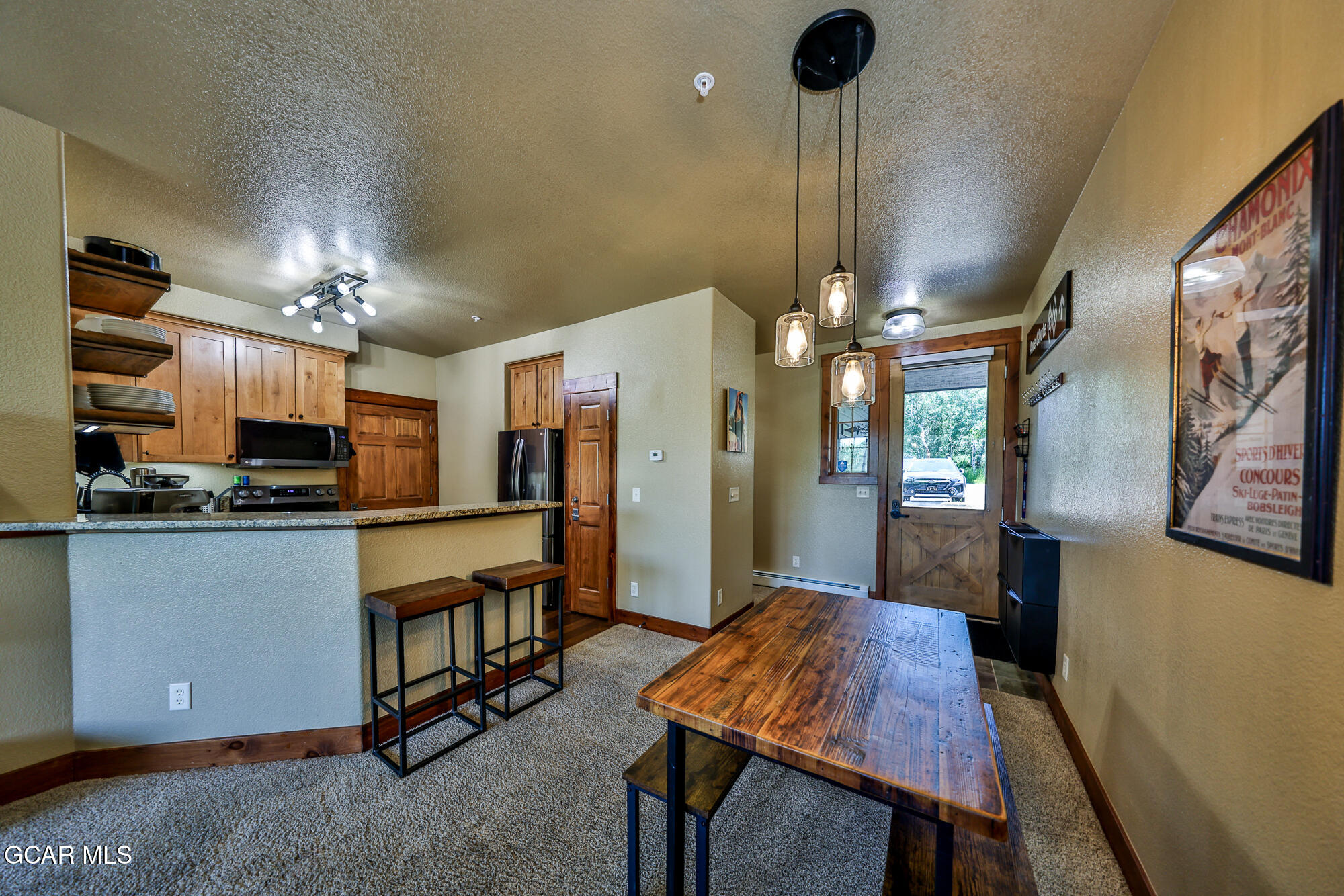 5202 Northstar, Unit 5202 Granby, CO 80446 - Photo 15 of 42 a kitchen with stainless steel appliances a dining table chairs stove and refrigerator