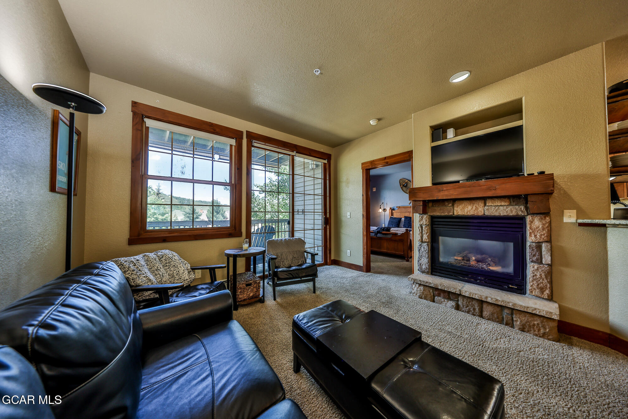 5202 Northstar, Unit 5202 Granby, CO 80446 - Photo 17 of 42 a living room with furniture flat screen tv and a fireplace