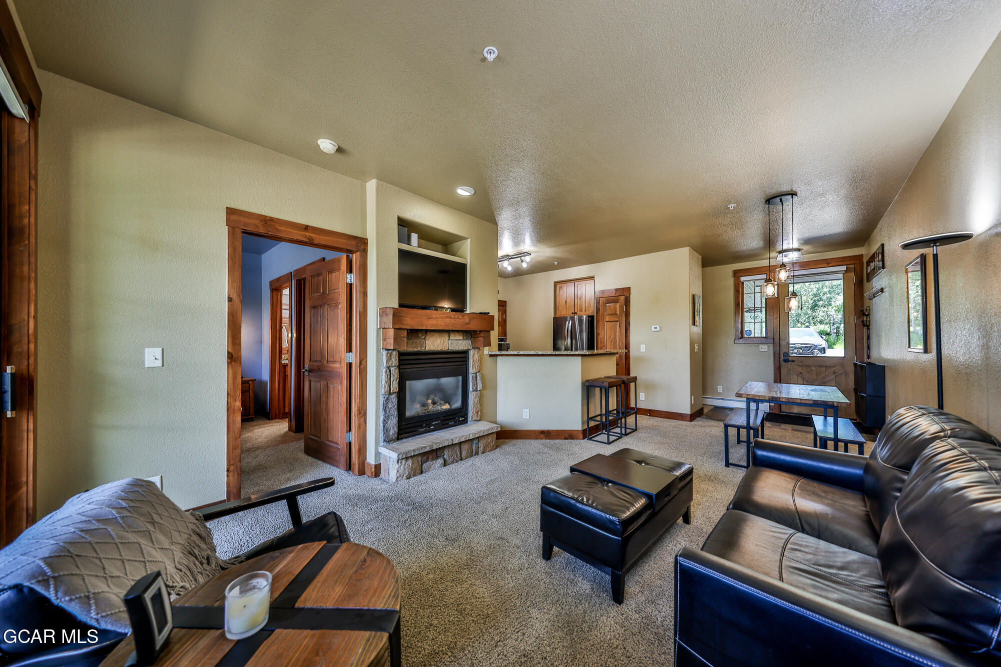 5202 Northstar, Unit 5202 Granby, CO 80446 - Photo 18 of 42 a living room with furniture kitchen view and a fireplace