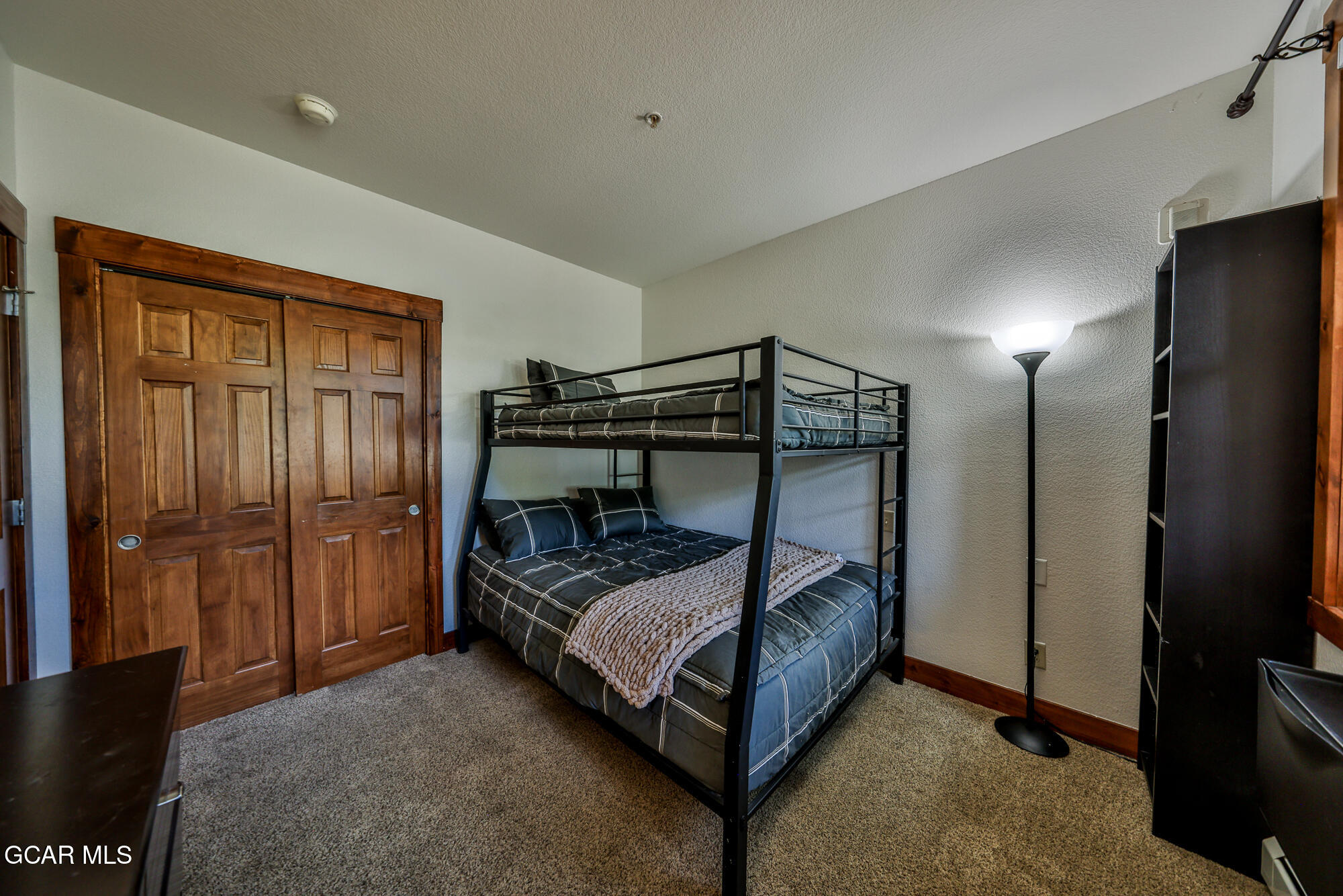 5202 Northstar, Unit 5202 Granby, CO 80446 - Photo 23 of 42 a bed sitting in a bedroom next to a bathroom