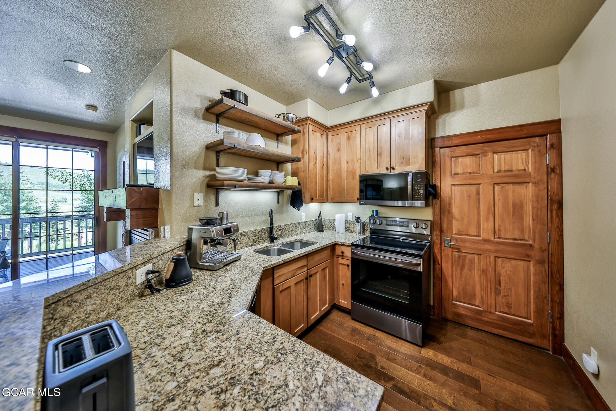 5202 Northstar, Unit 5202 Granby, CO 80446 - Photo 7 of 42 a kitchen with sink refrigerator and cabinets