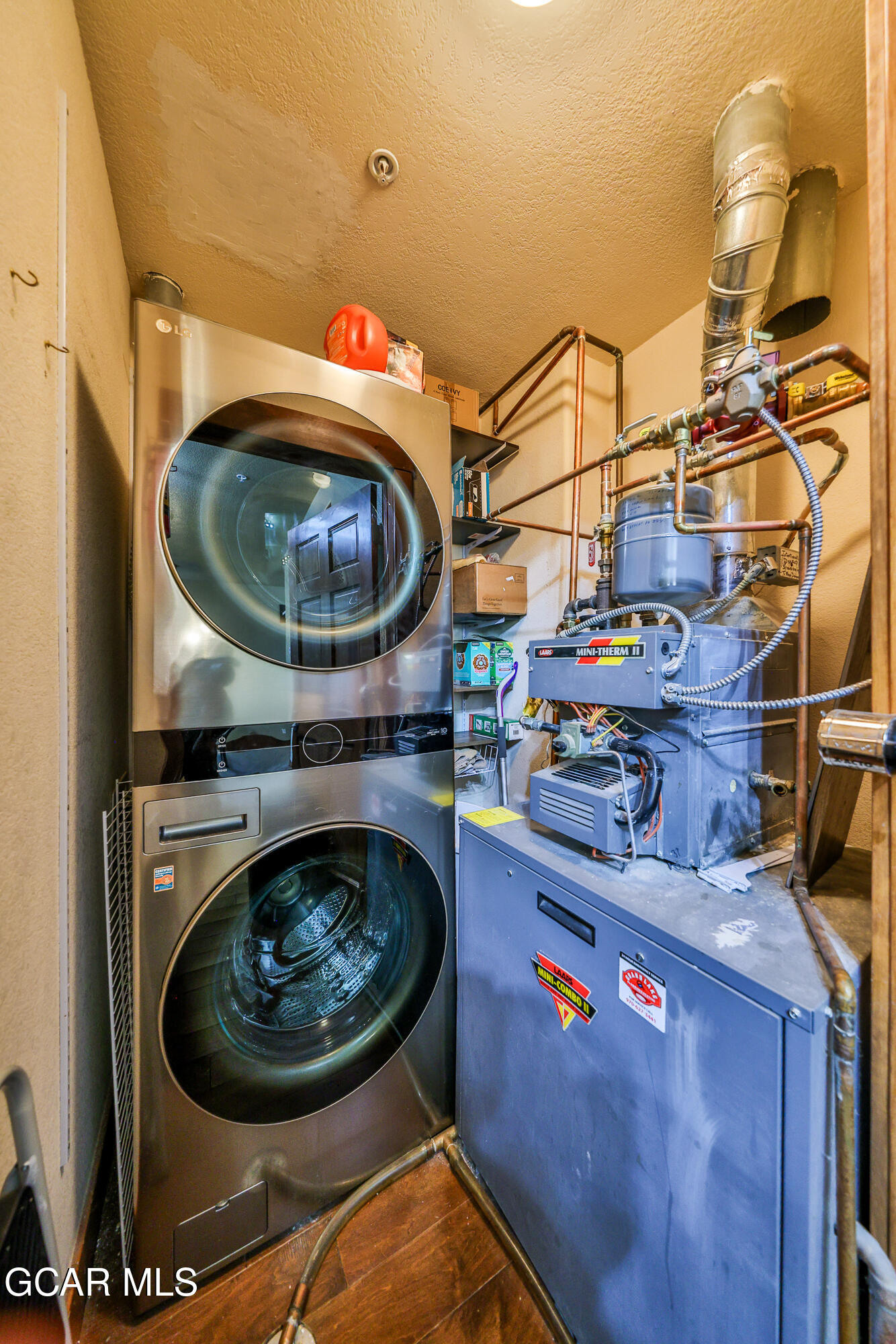 5202 Northstar, Unit 5202 Granby, CO 80446 - Photo 8 of 42 a utility room with a sink and wooden cabinets