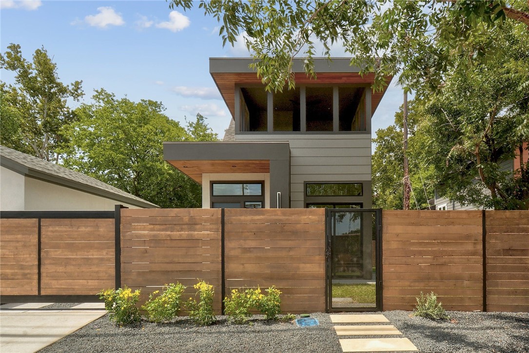 a front view of a house with a garden