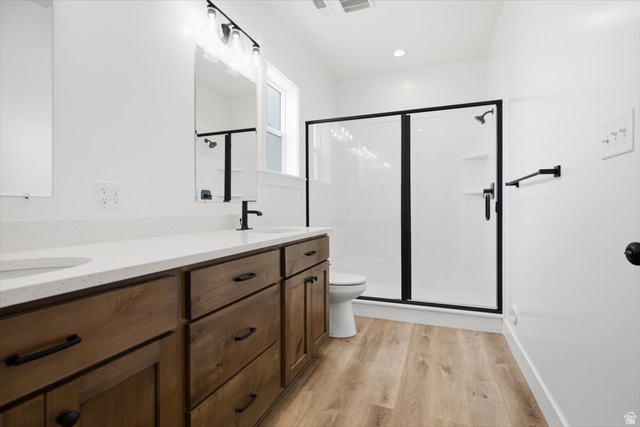 164 North 400 East Preston, ID 83263 - Photo 10 of 21 Spacious bathroom featuring a double vanity with wood cabinetry, white countertops, and dual undermount sinks
