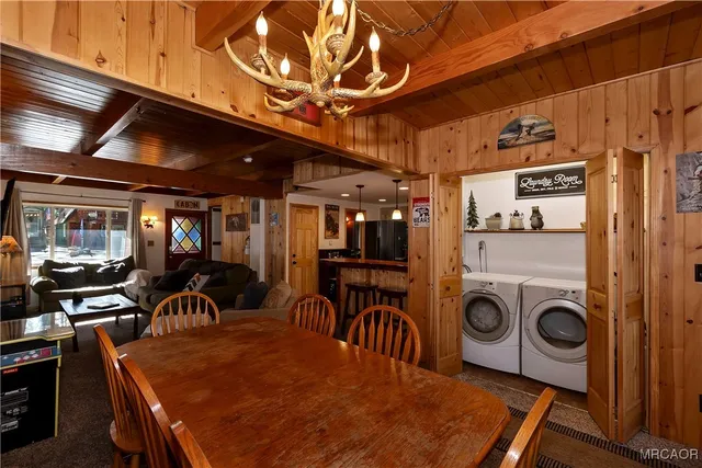 a view of a dining room with furniture and chandelier