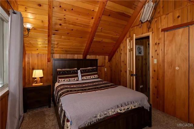 a bedroom with a bed and a balcony view