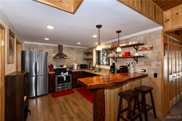 a kitchen that has a lot of countertop furniture and a refrigerator