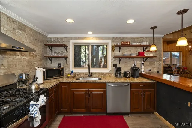a kitchen with a sink a stove and cabinets