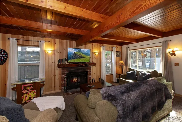 a living room with furniture a fireplace and a flat screen tv