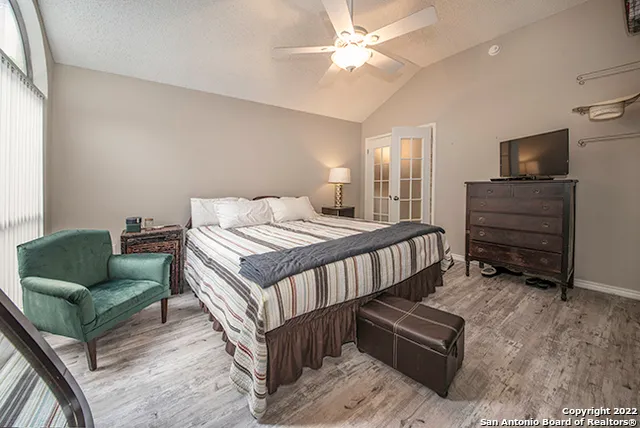 a bedroom with a bed a couch and a window